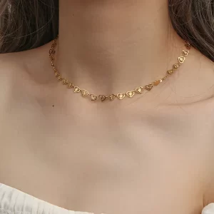 Model wearing an 18K gold-plated heart chain choker necklace with delicate heart-shaped links, adjustable fit, and a minimalist, elegant style.