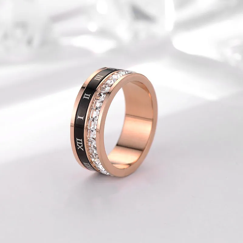 Rotating Roman numeral rose gold ring with cubic zirconia accents.