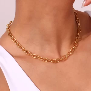 A model wearing a gold chain necklace, highlighting its elegant and versatile design against a white top.