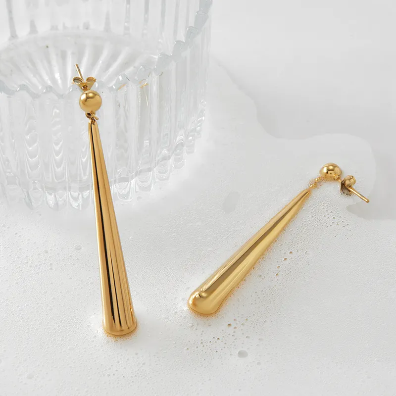 A pair of sleek gold spike earrings with a polished finish and modern design.
