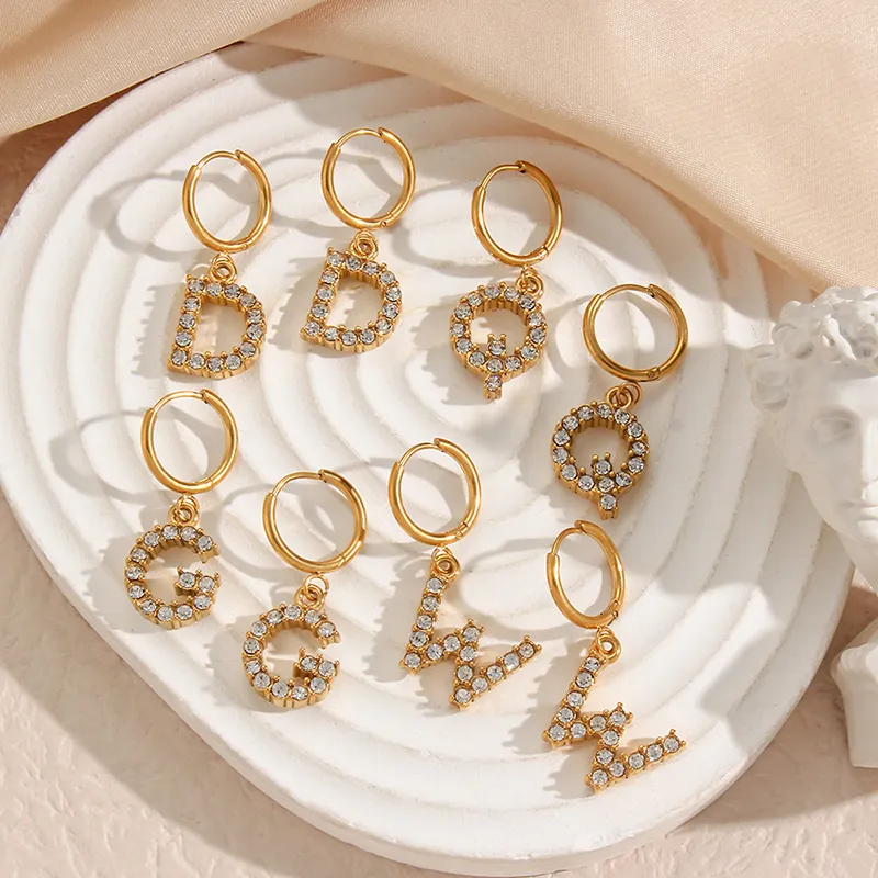 Gold hoop earrings with sparkling AAA zircon alphabet letter pendants, offering a customizable and elegant style.