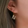 Gold hoop earrings with sparkling 'N' alphabet pendant, adorned with AAA zircon stones for a personalized and elegant look.