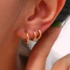 Gold triple hoop earrings, designed for a trendy layered look with a modern touch.