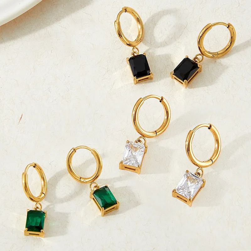 Gold hoop earrings featuring rectangular black, green, and clear cubic zirconia stones, sleek design.