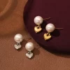 Pearl earrings with heart pendants in gold and silver, designed to be waterproof and fade-resistant.