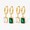 Gold hoop earrings with rectangular cubic zirconia and emerald green stone pendant, sparkling design.