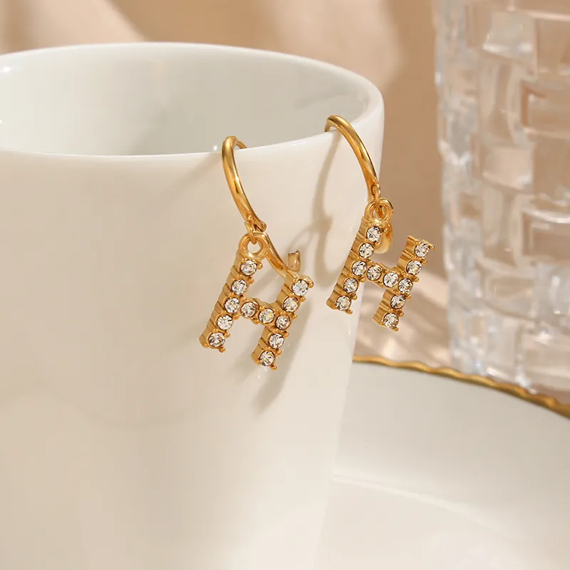 Gold hoop earrings with 'H' alphabet pendant, encrusted with AAA zircon stones for a personalized and sparkling appearance.