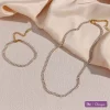 18K gold necklace and bracelet with marquise-cut cubic zirconia stones on a textured beige background, displayed with extended chains and adjustable clasps