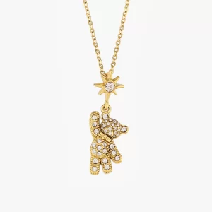 Gold teddy bear pendant with cubic zirconia stones and a star charm on a gold chain, displayed against a white background.