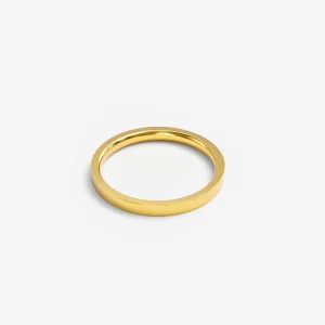 A sleek gold band ring on a neutral background, highlighting its minimalist elegance.