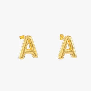 Close-up of gold balloon-style letter "A" stud earrings with a shiny, puffed design.