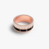 Rotating Roman numeral ring with cubic zirconia accents in rose gold.