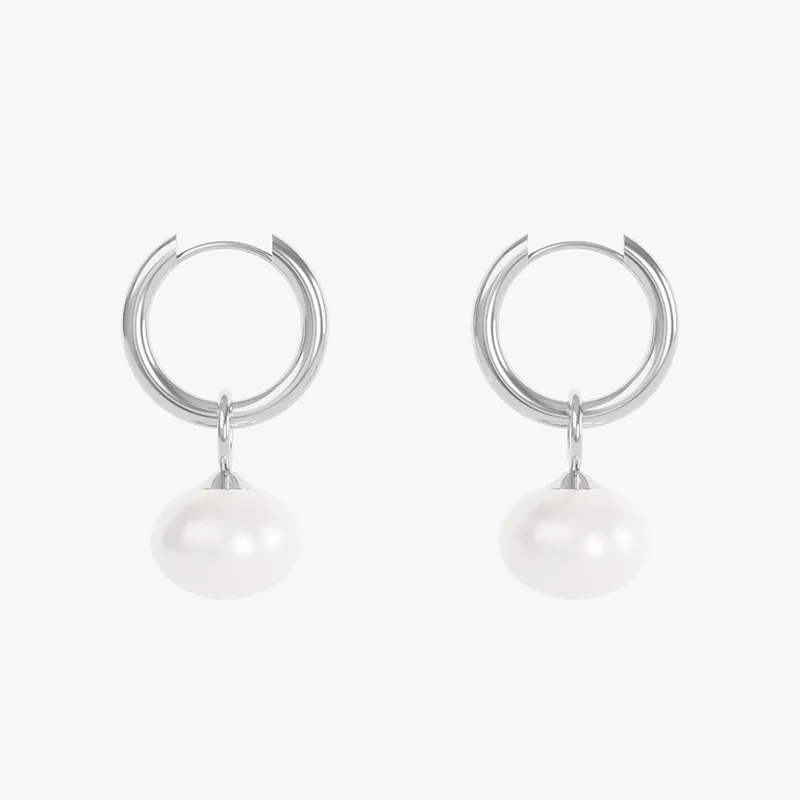 A pair of stainless steel hoop earrings with white pearl drops, designed to be waterproof and tarnish-resistant.