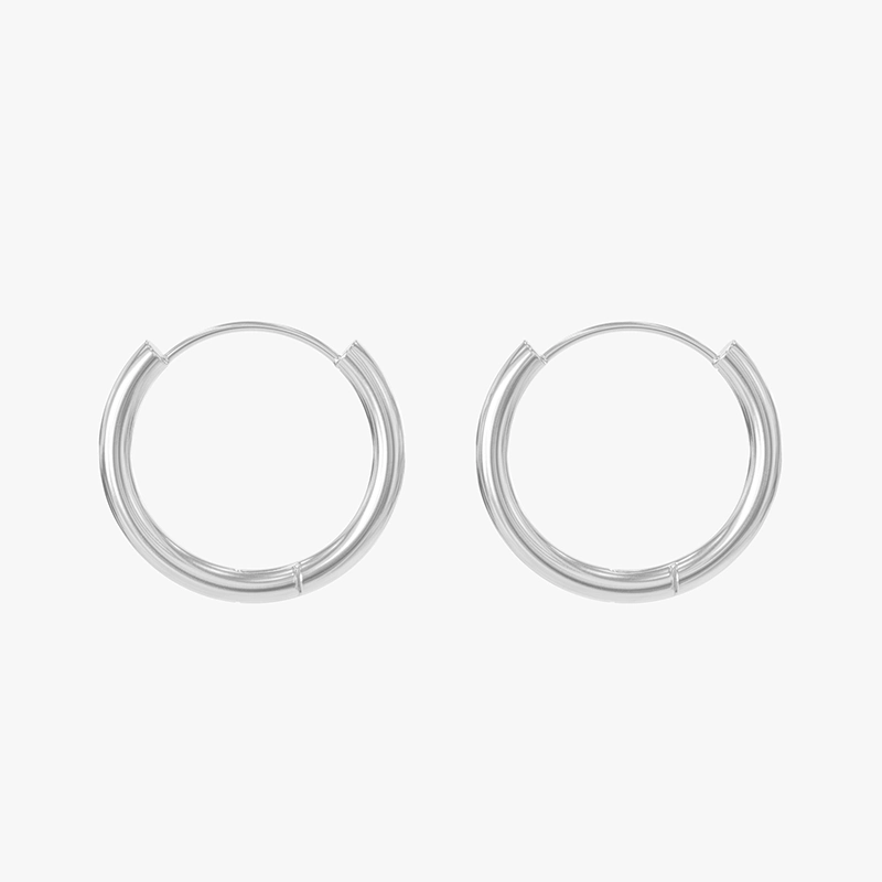 Close-up of silver hoop earrings with a sleek, polished design, ideal for everyday wear.