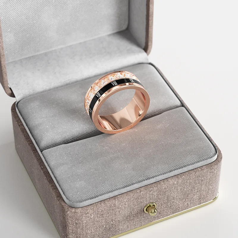 A rose gold-plated ring with a rotating band featuring Roman numerals, displayed in a gray velvet jewelry box, emphasizing its unique and elegant design.