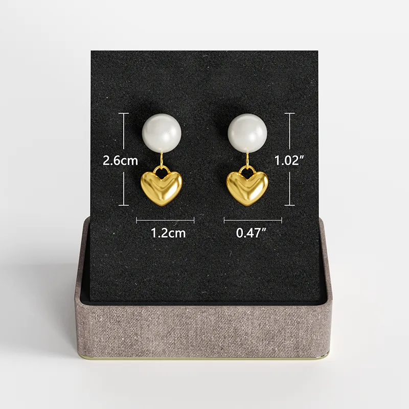A pair of 18K gold-plated pearl and heart drop earrings displayed on a black jewelry stand with size measurements, showcasing their elegant and delicate design.