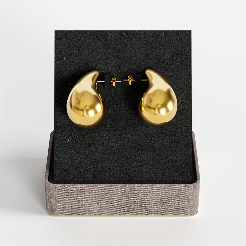 Gold teardrop stud earrings with polished finish, presented in a chic gift box.