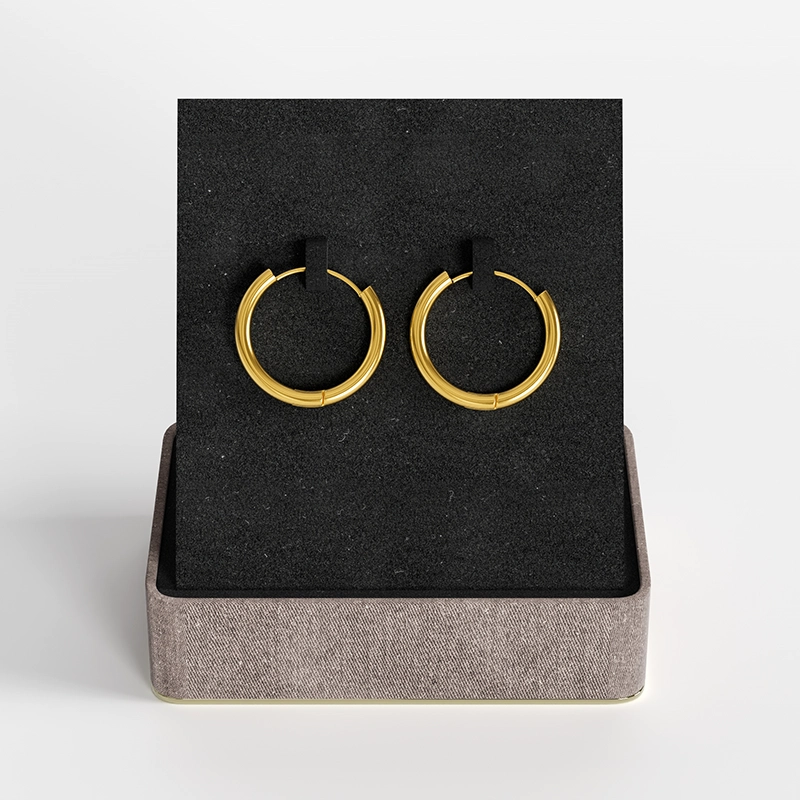 Gold hoop earrings with a sleek design, presented in a stylish gift box.