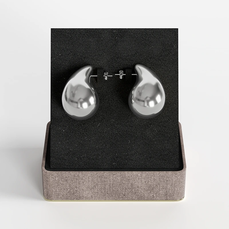 Stainless steel silver teardrop stud earrings with polished finish, presented in a gift box.