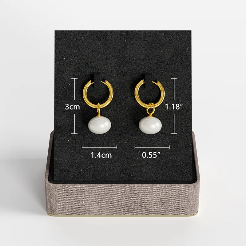 A pair of 18K gold-plated hoop earrings with white pearl drops, displayed on a black jewelry stand with size measurements indicated.